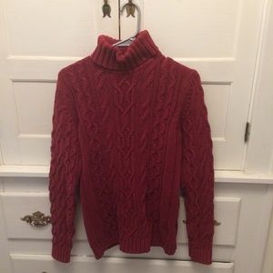 Red cableknit turtleneck sweater